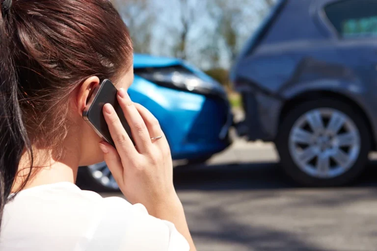 Person making a phone call after a car accident