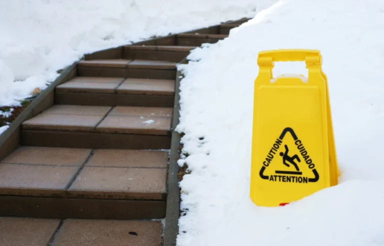 Slip and fall sign with snow on the ground