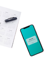 Image of a calendar and a mobile scheduling app