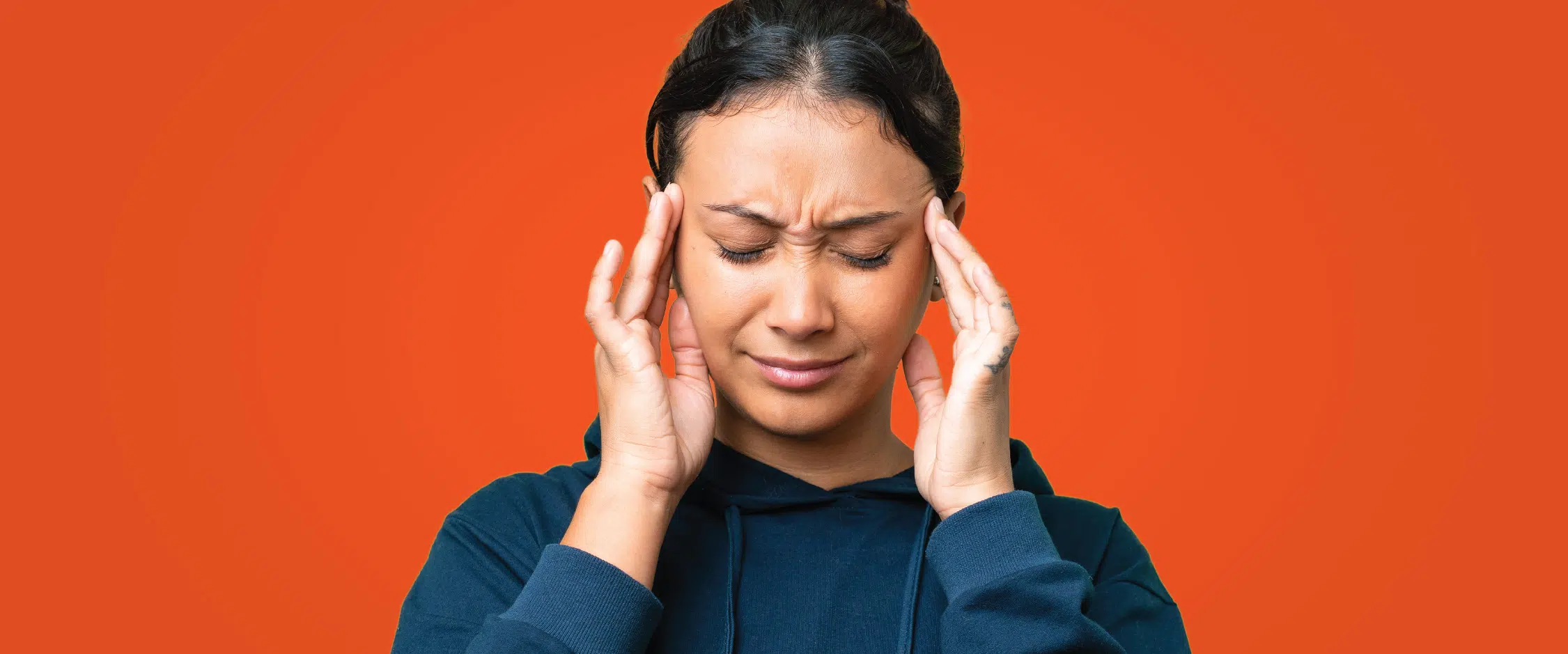 Woman holding head in pain
