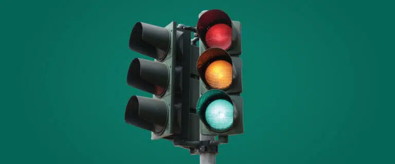 Stoplight on a green background
